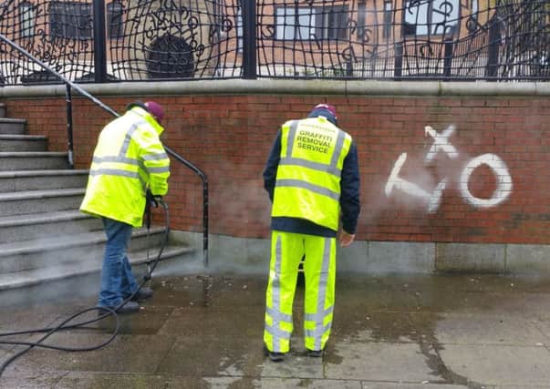 Cleaning graffiti is typical of the community service projects offenders participate in