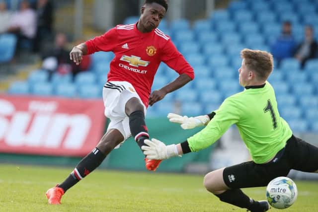 Manchester United Ademipo Odubeko scores past Co Fermanagh goal keeper Nathan Copeland