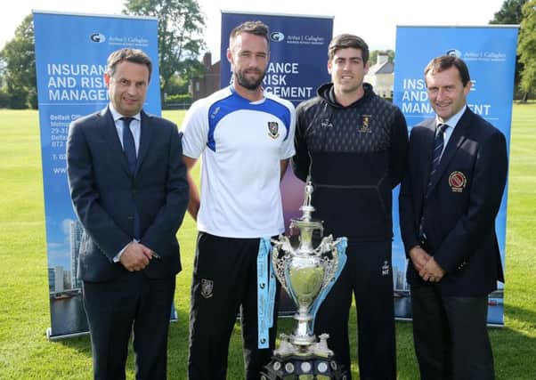 Rival captains Nigel Jones of CIYMS (second left) and Nikolai Smith of Instonians with the NCU Arthur J Gallagher Senior Challenge Cup they will compete for in the final in Comber on Saturday. Also included are, from left, Shane Matthews (regional managing director of Arthur J Gallagher) and Peter McMorran (president of the NCU).