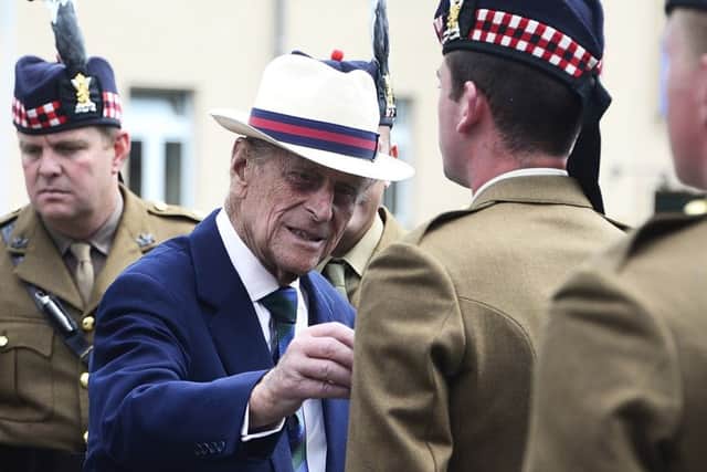 Prince Philip, pictured meeting troops in 2014, has supported the Queen as head of state for more than 65 years