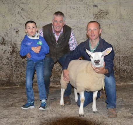 Texel Cross Ewe Lamb which was donated by the McFarlane Family in aid of Juvenile Batten Disease Research.  Pictured is Graham McFarlane and son with Open Night host Victor Chestnutt