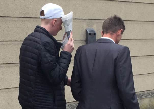 Mark Sloan, 18 (left), leaves Newry courthouse after appearing on a charge of sending a grossly offensive and indecent electronic message to DUP leader Arlene Foster.