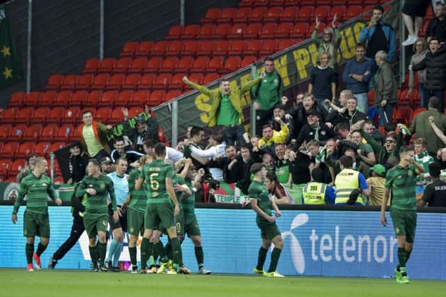 Celtic players celebrate James Forrest's goal with their fans during the Champions League, third qualifying round, 2nd leg soccer match between Rosenborg and Celtic at Lerkendal Stadium in Trondheim, Norway, . (Ole Martin Wold/NTB scanpix via AP)