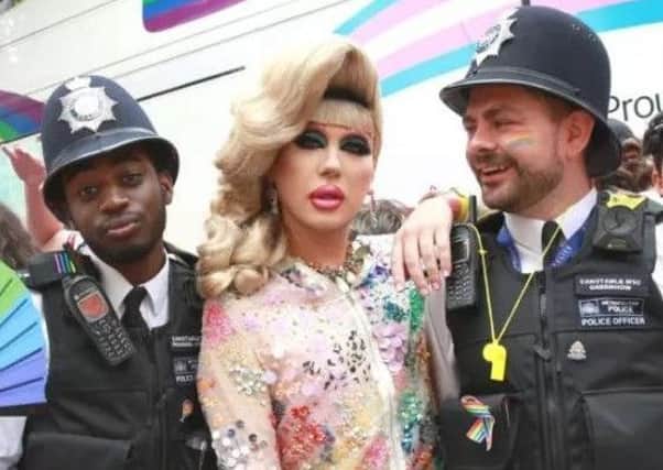 Police with cross-dresser Jodie Harsh at London gay pride on July 8.
