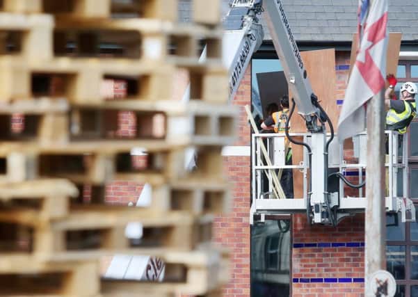 Press Eye Belfast - Northern Ireland 11th July 2017

Workmen board up windows of property beside a bonfire at the end of the Comber Greenway off Ravenscroft Avenue in east Belfast. 

Picture by Jonathan Porter/PressEye.com