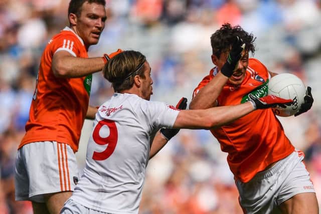 James Morgan of Armagh is tackled by Conall McCann of Tyrone