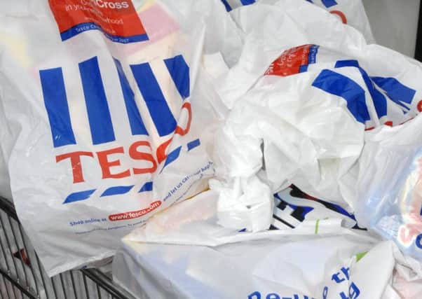 File photo dated 02/10/2007 of Tesco carrier bags in a shopping trolley. Photo credit: Ali Waggie/PA Wire