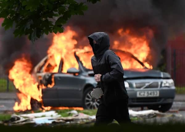 Masked men attack police who attended  the scene of  young people throwing stones and damaging cars in the Stewart Street area on Monday afternoon.
 Police said a number of cars have been damaged and officers are currently at the scene. 
Photo Pacemaker Press