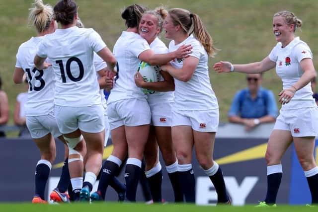 England's Kay Wilson celebrates scoring a try with her team mates