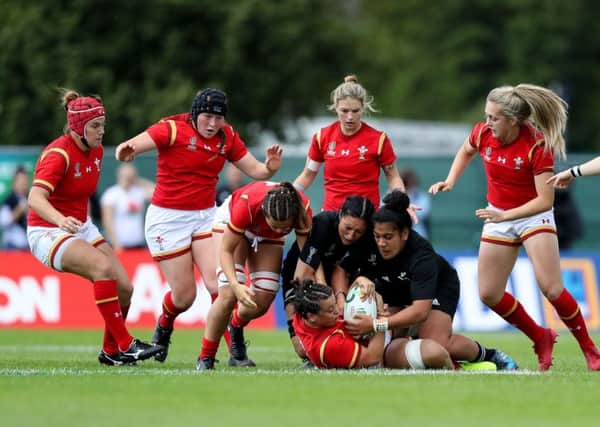 Wales Sioned Harries is tackled by New Zealands Sarah Goss and Victoria Subritzky-Nafatali
