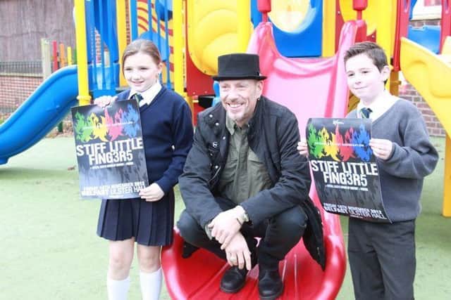 Stiff Little Finger's bassist Ali McMordie with two young fans