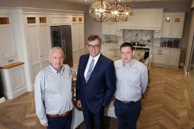 Invest NI CEO Alastair Hamilton pictured with Brian (left) and Connor McCloskey of Woodland Kitchens