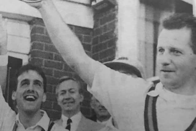 Garfield Harrison holds aloft the Challenge Cup, watched by Noel Nelson and, centre, then club president Sammy Gardiner