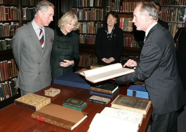 The Prince of Wales and the Duchess of Cornwall being shown a copy of the Belfast  News Letter from October 3, 1738, by John Killen, librarian at Belfast's Linen Hall Library. Picture by Brian Little February 2009