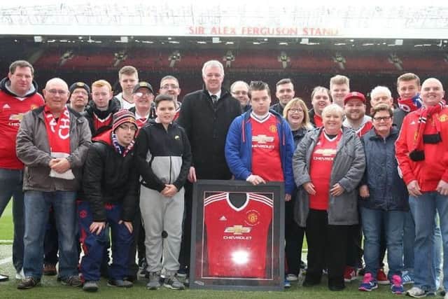 Members of Carryduff MUSC were presented with a signed shirt at Old Trafford on their 25 anniversary. Included in the photo is United legend Gary Pallister