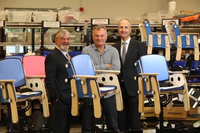 James Leckey founder and CEO of Leckey design, flanked by Dr Norman Apsley, CEO of Catalyst Inc, left, and Ian Sheppard, regional director with NI Bank of Ireland UK at the awrad-winning firms Lisburn headquarters