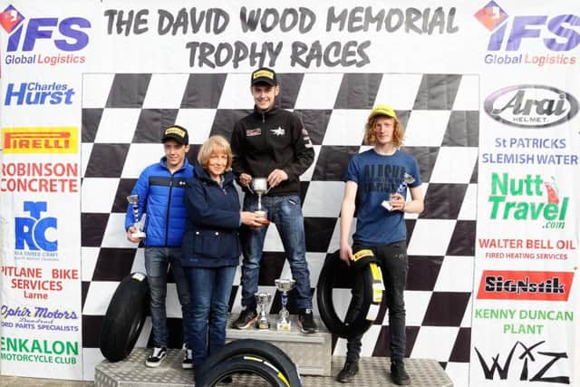 Jason Lynn receives the David Wood Memorial Trophy from Lee Wood at Bishopscourt on Sunday.