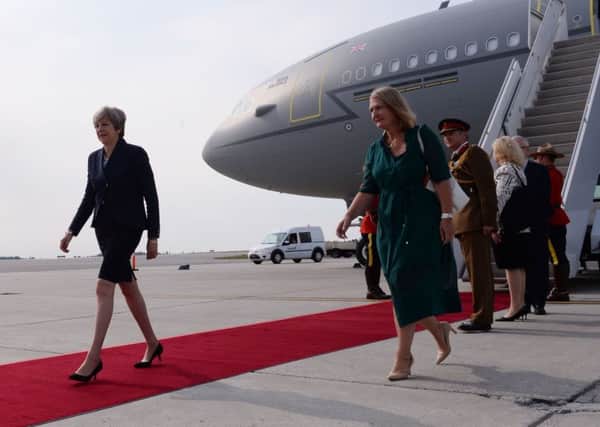 Prime Minister Theresa May (left) arrives in Ottawa, Canada, on Monday