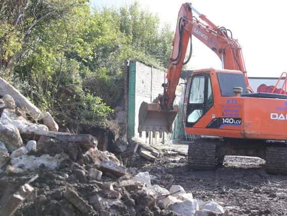 Handout photo of work to remove a three-metre high security wall that divides Springfield Road and Springhill Avenue in west Belfast.