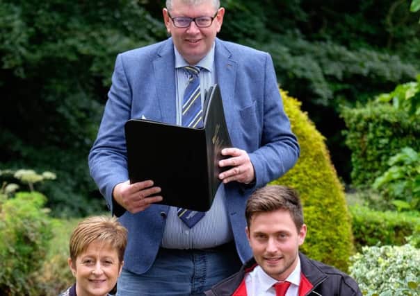 Announcing sponsorship of Holstein NI's Activities Card are club secretary/treasurer John Martin, and PR and events co-ordinator Julie Wallace, with Andrew Stewart, Lely Center Eglish. Picture: Columba O'Hare/Fotacol