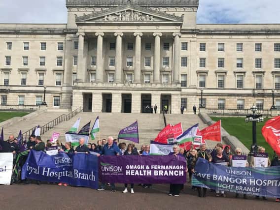 Representatives of medical bodies across Northern Ireland protest outside Parliament Buildings against 70m of budget cuts to health trusts