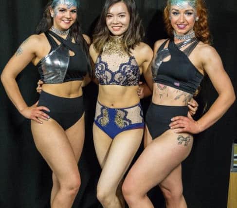 Lisburn woman Tanya Cheung (centre), was crowned overall winner of the All-Ireland Pole Dance Competition 2017 in Belfast on Saturday night. She's pictured with Flyaway Aerial Studio students Emily Strudley and Rebecca McWhinney, who took third place in the doubles category at the same competition.