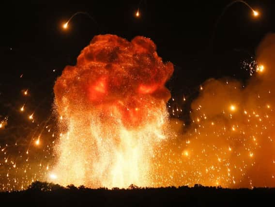 A powerful explosion is seen in the ammunition depot at a military base in Kalynivka, west of Kiev, Ukraine, early Wednesday, Sept. 27, 2017. Ukrainian officials say they have evacuated more than 30,000 people after a fire and ammunition explosions, at the military base. (AP Photo/Efrem Lukatsky)