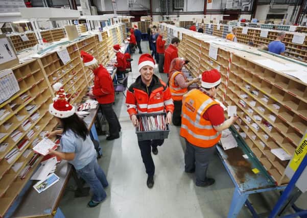 File photo dated 16/12/15 of employees at Royal Mail's Glasgow Mail Centre wearing Santa hats, as Royal Mail launched a drive to recruit around 20,000 temporary workers during the busy Christmas period. Photo by Danny Lawson/PA Wire
