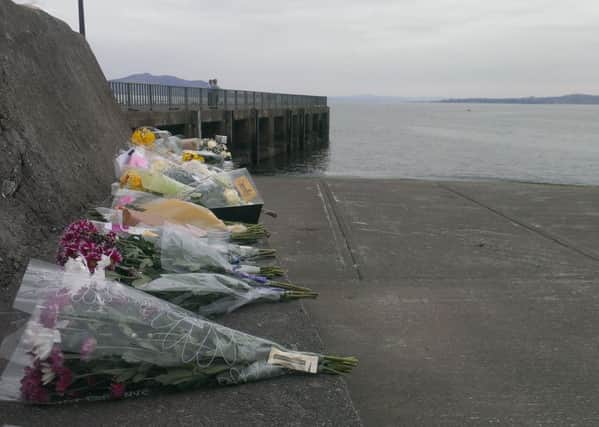Floral tributes were left at Buncrana Pier following the tragedy in March 2016.