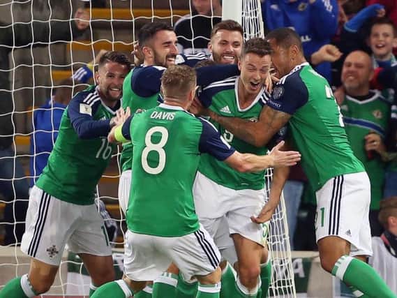 Jonny Evans was mobbed by his international team-mates when he opened the scoring against Czech Republic