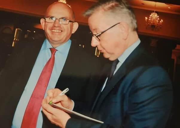 Michael Gove, right, pictured with DUP councillor John Finlay at the event