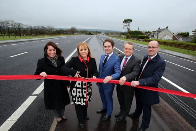 The 2016 opening of the Â£133 million A8 dual carriageway to Larne, which means there is a dual carriageway or motorway down almost the entire east coast to Rosslare in Co Wexford.
Left-Right Deidre Mackle (Transport NI Divisional Manager) Transport Minister Michelle McIlveen, Enrique Nieto (Ferrovial) Adrian Bennett (Costain) and John Cunningham (Lagan)
