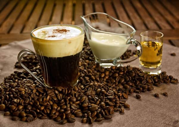 Warm Irish Coffe with coffee beans, whiskey and cream