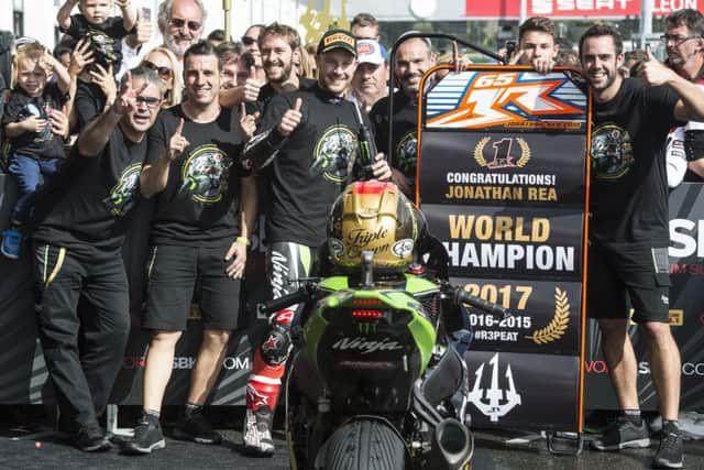 Jonathan Rea celebrates with his Kawasaki team at Magny-Cours in France on Saturday after winning a record third successive World Superbike Championship.