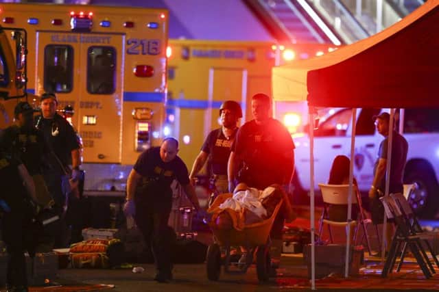 A wounded person is walked in on a wheelbarrow as Las Vegas police respond after the incident in Las Vegas