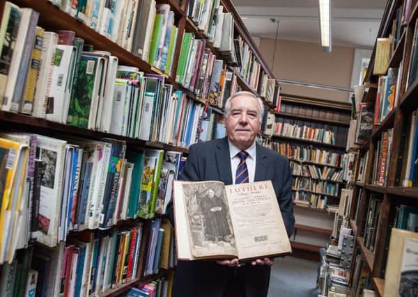 Rev Ron Johnstone with a copy of Luthers Divine Discourses, dated 1652, which is one of the most notable exhibits at the Luther exhibition, hosted at the Linen Hall Library in Belfast. Image sent in by Orange Order 02-10-17