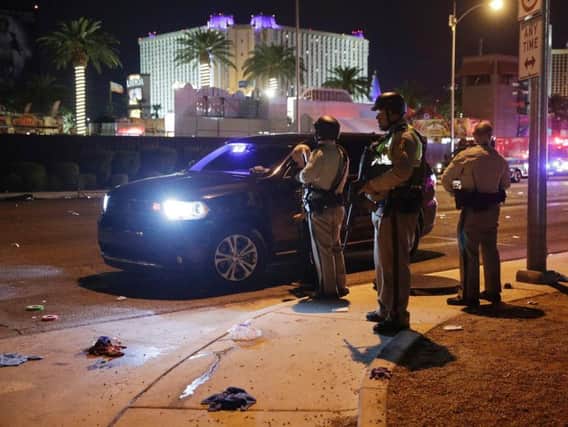 Las Vegas Police stand at the scene of a shooting along the Las Vegas Strip