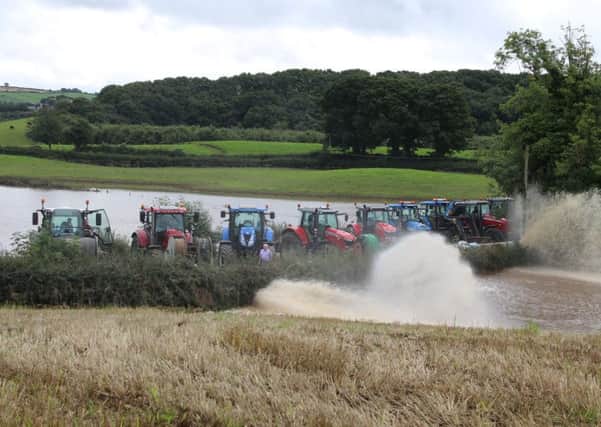 A team of tractors tackle floodwaters