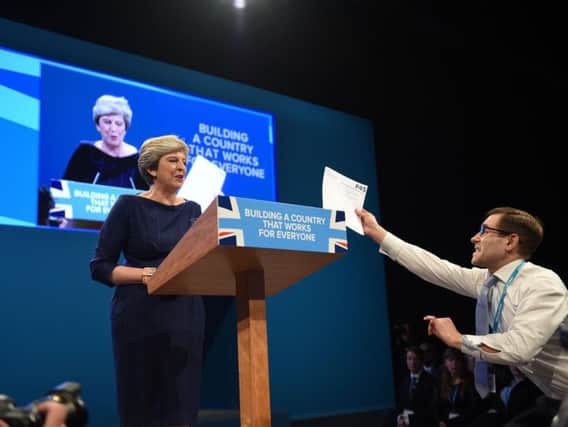 Comedian Simon Brodkin, also known as Lee Nelson confronts Prime Minister Theresa May during her keynote speech at the Conservative Party Conference at the Manchester Central Convention Complex