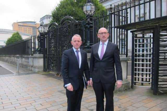 Andrew Trimble and Tom Forgrave, executive chairman and director of the Renewable Heat Association NI, outside the High Court in Belfast