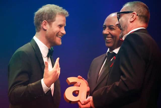 Prince Harry (left) receives a posthumous Legacy award on behalf of his mother Diana, Princess of Wales, from Ian Walker, (right) and Julian La Bastide, at the Attitude Awards in London.