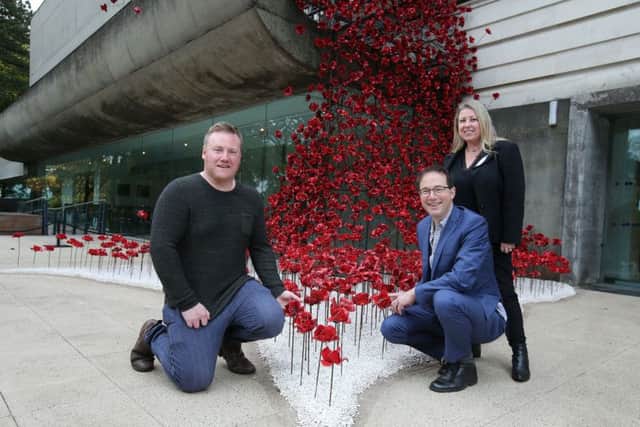 Press Eye - Belfast - Northern Ireland - 13th October 2017 - 

ICONIC POPPIES OPEN IN BELFAST
 
The iconic poppy sculpture Weeping Window by artist Paul Cummins and designer Tom Piper will open tomorrow, Saturday 14 October, at the Ulster Museum, Belfast.  The poppies will be on site until 3 December 2017 as part of the UK-wide tour organised by 14-18 NOW, the UK's arts programme for the First World War centenary. The poppies are presented by National Museums NI and Belfast International Arts Festival to give people from Northern Ireland and across the island of Ireland the opportunity to see the sculpture.

Pictured at the sculpture are, from left to right,  Artist Paul Cummins, Designer Tom Piper and Kim Mawhinney, Head of Art, National Museums NI.

Photo by Kelvin Boyes  / Press Eye