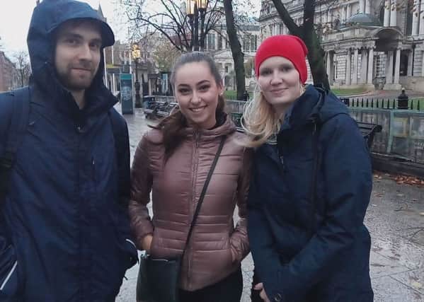 John Honza, left, Petra Zaplova, and Annie Kabelaova from Czech Republic at around 6pm, just before the height of the storm in Belfast city centre. They all thought the weather was not too bad and were surprised to find everything shut. By Ben Lowry