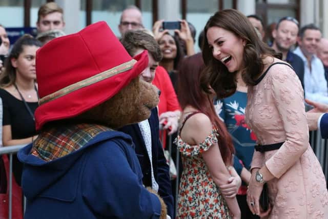 The Duchess of Cambridge dances Paddington bear on platform 1 at Paddington Station, London, as she attends the Charities Forum event, joining children from the charities she supports