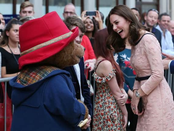 The Duchess of Cambridge dances Paddington bear on platform 1 at Paddington Station, London, as she attends the Charities Forum event, joining children from the charities she supports