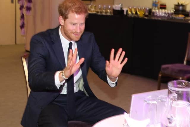 Prince Harry greets the winning team of health professionals using a video link to Belfast after Ophelia forced a flight cancellation