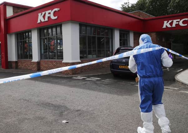A forensics officer at the scene of Mr Gibson's death at the KFC premises at Yorkgate