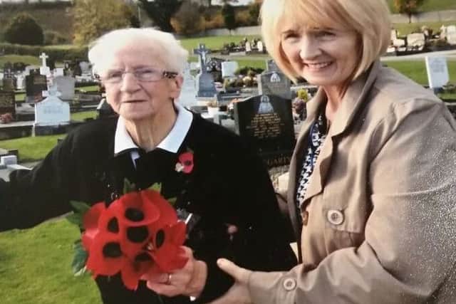 Nellie O'Donnell visits her father's grave last year with her daughter Evelyn Gallagher