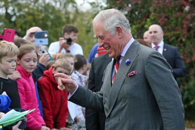 The Prince of Wales meets well-wishers outside the Eglinton Community Centre in Londonderry during a visit to communities hit by the summer's flash floods