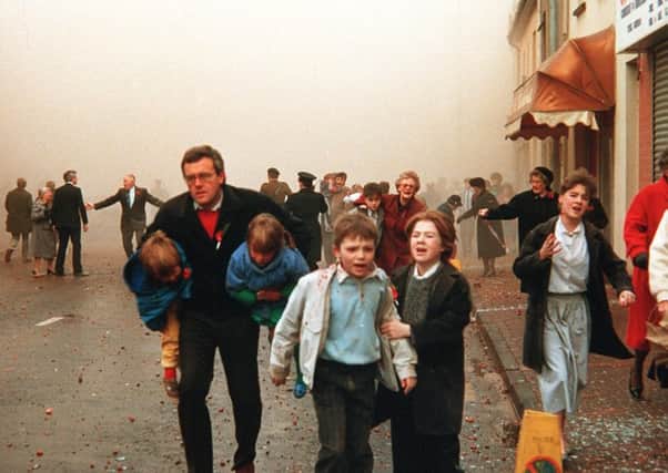 Children being led away from the scene of the Enniskillen bombing in 1987